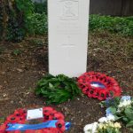 Photo of Private Harris headstone, wreaths and flowers